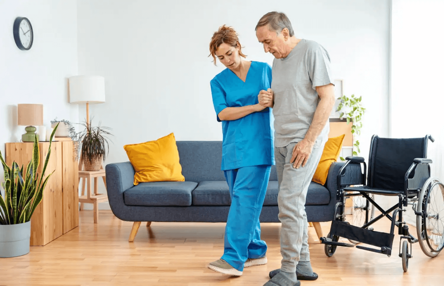 Caregiver providing steady mobility support as an older man walks.